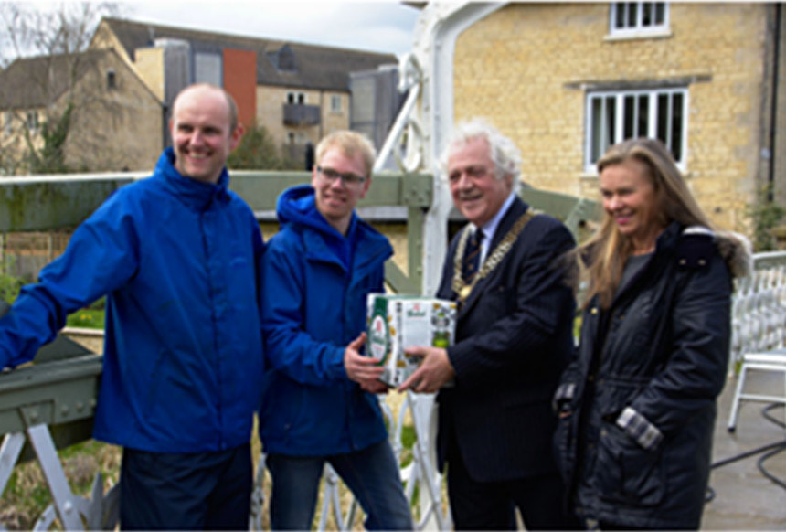 The Stamford Pressure Washes’ team receive a welcome beer from Mayor John Dawson and Paddy Jelen